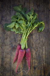 Organic red radish on dark wood - LVF004564