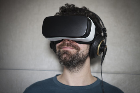 Man wearing Virtual Reality Glasses and headphones stock photo