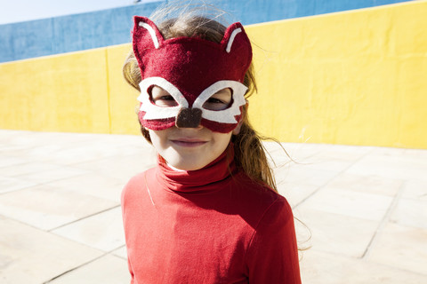 Portrait of little girl wearing animal mask stock photo