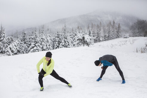 Ehepaar beim Aufwärmen für einen Langlauf im Winter - HAPF000242