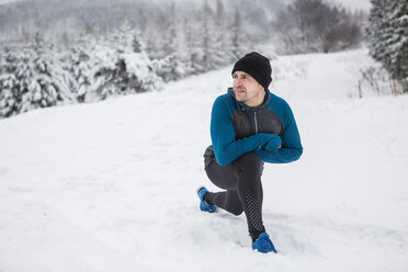 Man warming up for cross country run in winter - HAPF000246