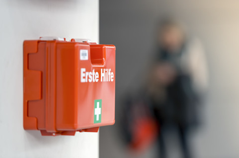 First aid box hanging on the wall stock photo