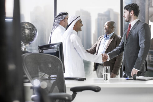 Western businessmen having meeting in Middle Eastern office - ZEF008589