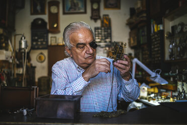 Watchmaker with okular working with an old watch - KIJF000205