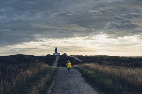 Frankreich, Bretagne, Pointe du Raz, Junge geht zu den Leuchttürmen Phare de la Vieille und Phare de Tevennec, lizenzfreies Stockfoto