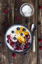 Bowl of natural yoghurt with mango pulp, grits, coconut flakes and fruits - SARF002602