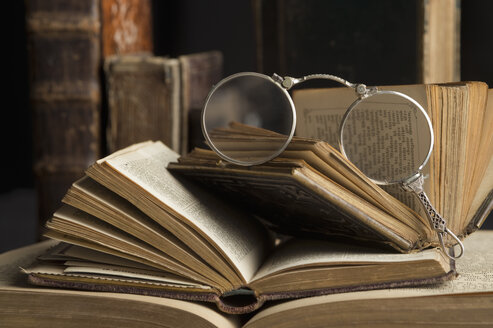 Lorgnette on stack of antique books - CRF002740