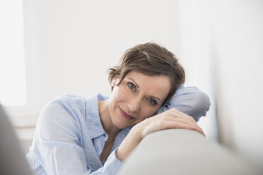 Portrait of relaxed woman on couch - FMKF002411