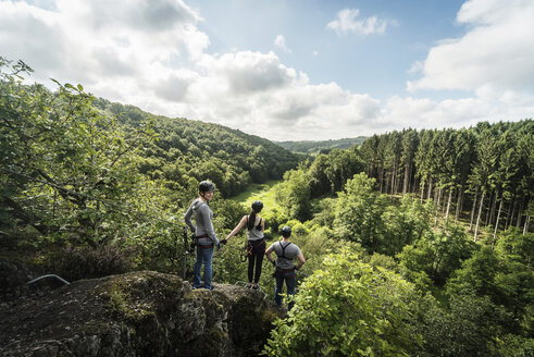 Germany, Westerwald, Hoelderstein, three friends on via ferrata looking at view - PAF001554