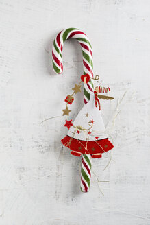 Candy cane with angel figurine on white wood - MYF001365