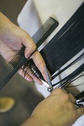 Hairdresser cutting the hair of a girl - ABZF000241