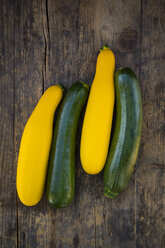 Two yellow and two green zucchini on dark wood - LVF004605