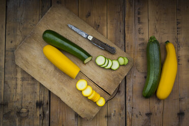 Whole and sliced yellow and green zucchini on wood - LVF004607