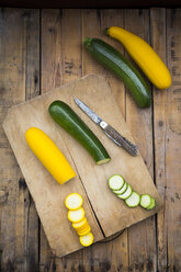 Whole and sliced yellow and green zucchini on wood - LVF004608