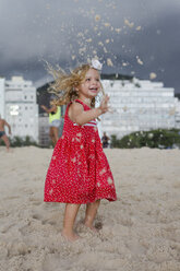 Brasilien, Rio de Janeiro, Mädchen spielt mit Sand am Strand der Copacabana - MAUF000276