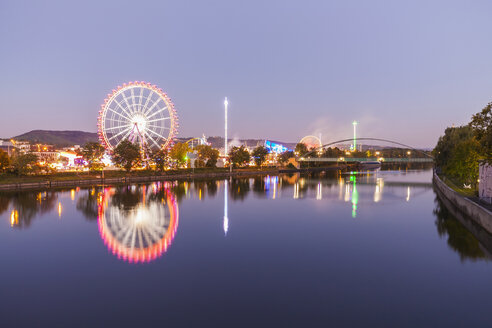 Germany, Stuttgart, Cannstatter Wasen fairground in the evening - WDF003551