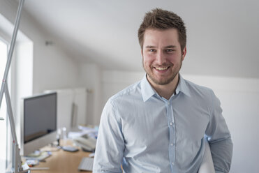 Portrait of smiling young man in office - PAF001605