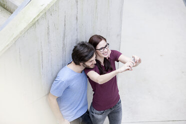 Young couple taking selfie with smartphone - FMKF002493