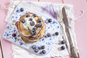 Stack of American pancakes with whipped cream and blueberries - SBDF002707