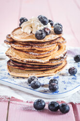 Stack of American pancakes with whipped cream and blueberries - SBDF002708