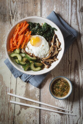 Vegetarian korean rice bowl with mushroom, spinach, cucumber, carrot and fried egg - EVGF002836