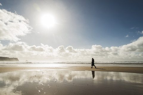 France, Bretagne, Finistere, Crozon peninsula, woman walking on the beach stock photo