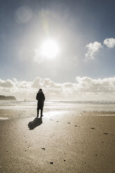 Frankreich, Bretagne, Finistere, Halbinsel Crozon, Frau steht am Strand - UUF006707