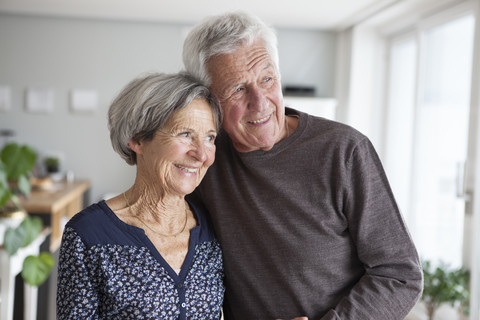 Portrait of happy senior couple at home stock photo