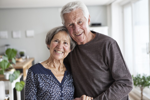 Portrait of happy senior couple at home stock photo