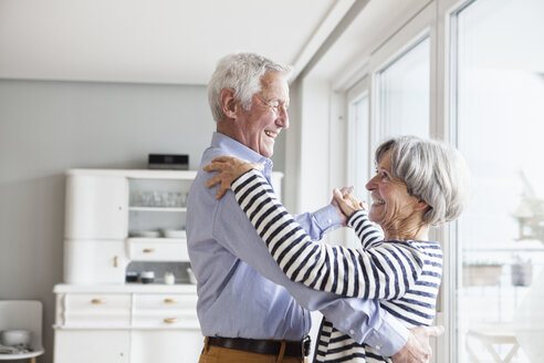 Senior couple dancing together at home at home - RBF004150