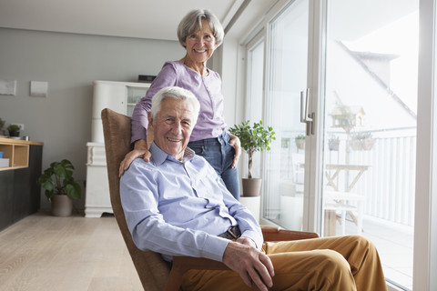 Portrait of relaxed senior couple at home stock photo