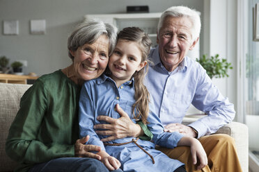 Family portrait of grandparents and their granddaughter at home - RBF004200