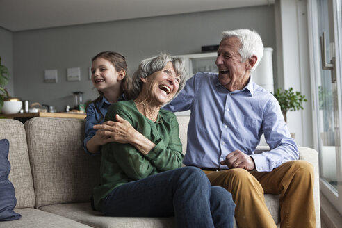 Little girl and her grandparents having fun at home - RBF004202