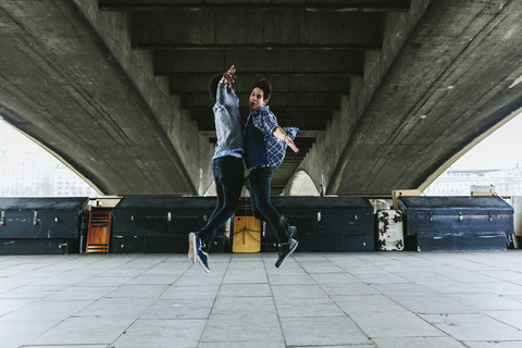 UK, London, two young man junping in the air stock photo