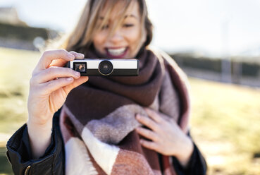 Woman taking a picture with an antique camera - MGOF001501