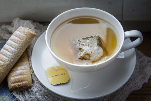 Chamomile tea and biscuits on window sill - SBDF002723