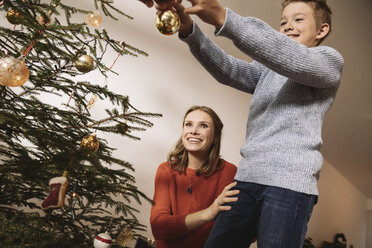 Mother and son decorating Christmas tree - MFF002801
