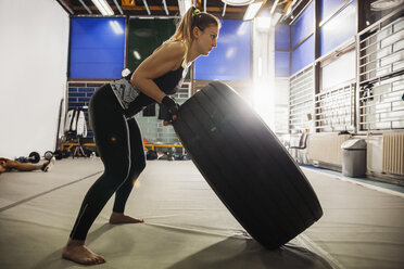 Frau trainiert mit Reifen im Fitnessstudio - ZEDF000068