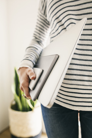 Woman holding portable devices in different sizes stock photo