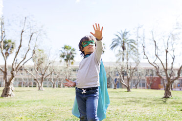 Little boy dressed up as a superhero posing on a meadow - VABF000349