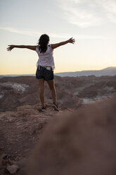 Chile, San Pedro de Atacama, woman in the Atacama desert with outstretched arms - MAUF000344