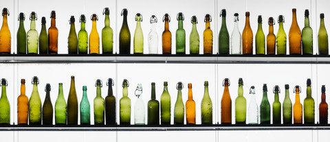 Two rows of different beer bottles stock photo