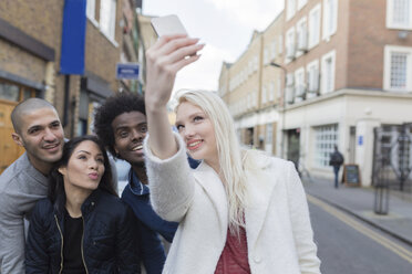 Group of happy friends taking a selfie on urban street - BOYF000173