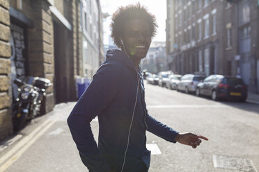 Young man listening to music on urban street - BOYF000188