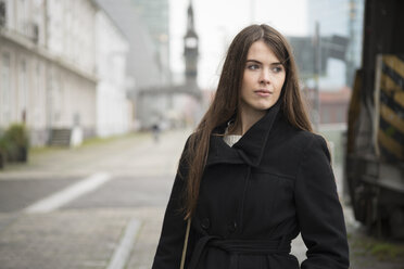 Young woman wearing black coat outdoors - LFOF000202