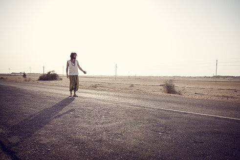 Man travelling alone on country road - BMAF000122