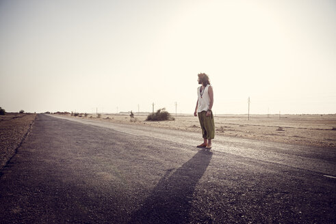 Man travelling alone on country road - BMAF000123