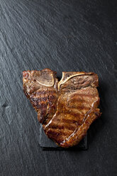 Roasted porterhouse steak on black - CSF027297