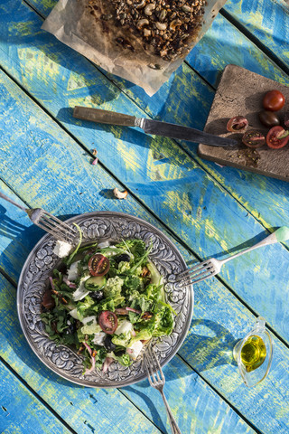 Greek salad with arugula, cheece, olives, tomatoes, cucumber, onion and caramelized nuts stock photo