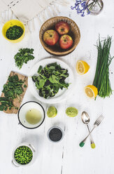 Preparing salad of peas, baby spinach, watercress, chives, apple and black sesame with dressing of lime and sesame oil - DEGF000736